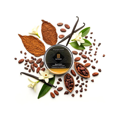 Rithim Tobacco Vanilla Beard balm container surrounded by tobacco leaves, vanilla beans, and vanilla flowers on a white background